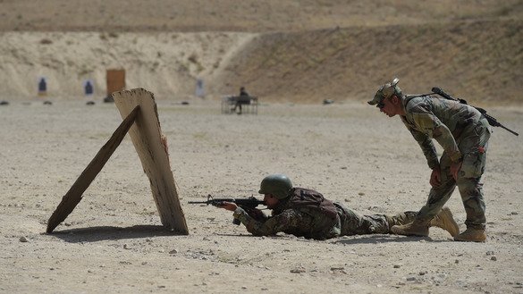 In this photograph taken on August 10, 2017, an Afghan commando opens fire during live firing exercises at Camp Morehead on the outskirts of Kabul. [Shah Marai/AFP]