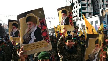 A photo circulated on social media earlier in February shows members of the Fatemiyoun Division marching in Mashad, Iran, holding portraits of the country's supreme leader, Ali Khamanei.