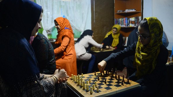 Students play chess at the Bibi Sarai training and recitation centre in Herat July 14. [Hoshang Hashimi/AFP]