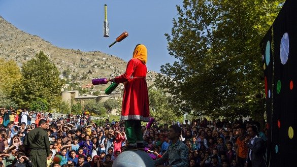 A juggler performs during the Mobile Mini Circus for Children at the Bagh-e-Babur Garden in Kabul on August 1, 2018. [Wakil Kohsar/AFP]