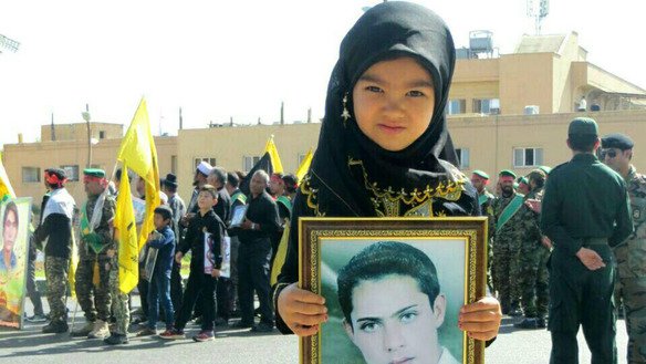A child of a dead Fatemiyoun fighter attends a parade marking Sacred Defence Week September 23 in Kashan District, Isfahan Province, Iran. [File]