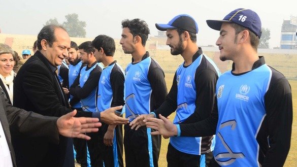 Commissioner for Afghan Refugees in KP Muhammad Abbas Khan greets Afghan players in Peshawar December 5. [Shahbaz Butt]