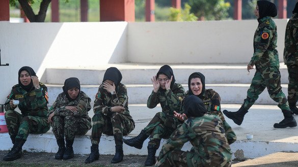 Female Afghan army officers take a break between firing exercises at the OTA in Chennai, India, December 19. [ARUN SANKAR/AFP]