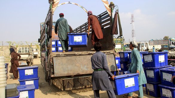 Employees of the Independent Election Commission (IEC) load ballot boxes on trucks in Khost Province September 26. [FARID ZAHIR/AFP]