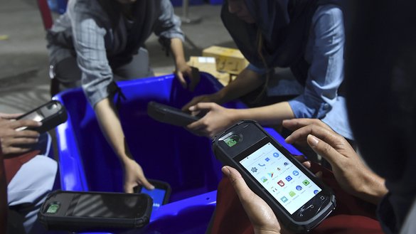 In this photo taken on September 16, an employee of the Independent Election Commission (IEC) checks biometric fingerprint readers, part of a massive effort to ensure Afghanistan's upcoming presidential election is not tainted by fraud allegations that have marred previous polls. [WAKIL KOHSAR/AFP]
