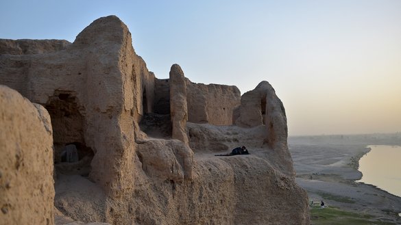 An internally displaced Afghan man rests inside the ruins of a palace where internally displaced families live at the historic site of Qala-e-Kohna in Lashkargah, the capital of Helmand province, on March 27. [Wakil Kohsar/AFP]