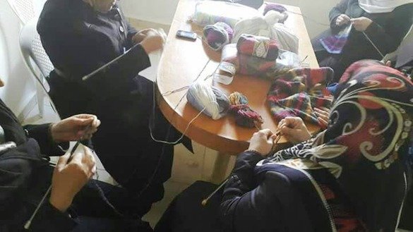 Syrian women knit warm winter clothing as part of a small enterprise project supported by Damma, a women-founded non-governmental organisation. [Photo courtesy of Damma]