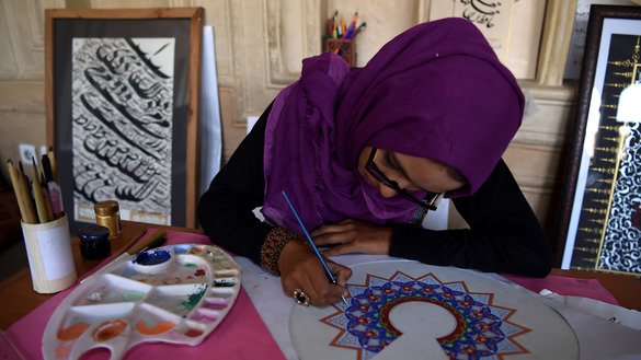 An Afghan student practises calligraphy. [Wakil Kohsar/AFP]