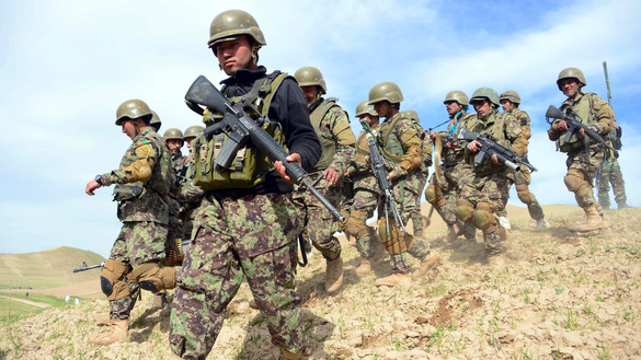 In this photograph taken on March 24, 2017, Afghan National Army (ANA) soldiers march to their positions during a military operation in Badghis Province. [HOSHANG HASHIMI/AFP]