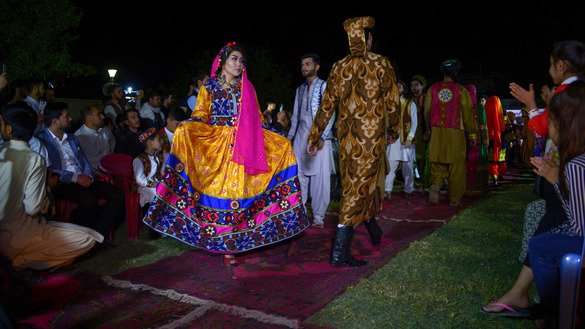 Afghan models stroll down a catwalk during a fashion show April 10 in Mazar-e-Sharif. [Farshad Usyan/AFP]