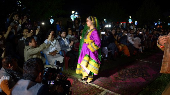 A female Afghan model poses for pictures during a fashion show April 10 in Mazar-e-Sharif. New generations of Afghan women have been bringing positive social changes to the nation. [Farshad Usyan/AFP]