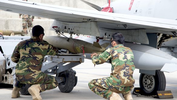 AAF A-29 maintainers manoeuvre a bomb in place before attaching it to an Afghan A-29 on March 6, at Kabul Air Wing. All training for AAF ammunition operations is conducted in the country by Afghans. [Staff Sgt. Jared J. Duhon/US Air Force]