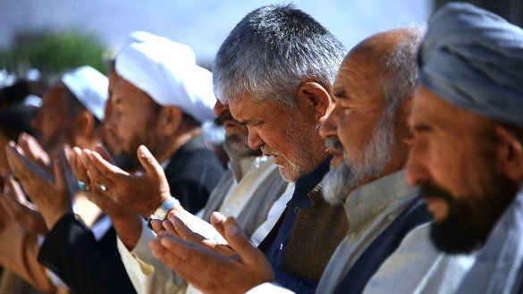 Men offer prayers June 15, the first day of Eid ul Fitr, in Herat Province. [Hoshang Hashimi/AFP]