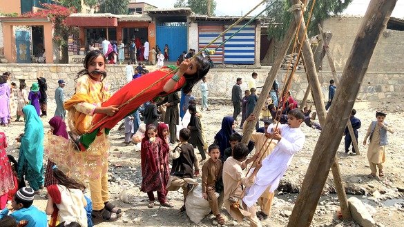 Boys and girls ride swings and play in Asadabad, Kunar Province, June 15. [Khalid Zerai]