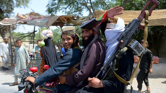 Taliban militants ride a motorbike as they celebrate the second day of Eid ul Fitr in the outskirts of Jalalabad June 16. [Noorullah Shirzada/AFP]