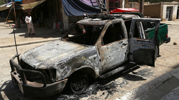 A burnt police vehicle is pictured August 16 after a Taliban attack in Ghazni. [ZAKERIA HASHIMI/AFP]