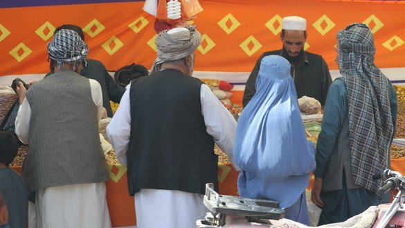 Residents buy goods at a market in Herat August 19. [Nasir Salehi]