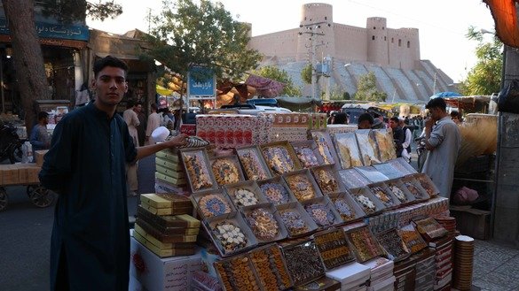 بتاریخ ۲۸ اسد، یک مرد جوان در هرات در آستانه جشن های عید شیرینی‌جات و حلویات می فروشد. [نصیر صالحی]
