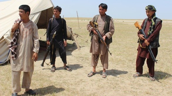 Members of an Afghan militia look on during fighting between Taliban militants and Afghan security forces near the Qala-e-Zal District in Kunduz Province on May 7, 2017. Taliban fighters who have surrendered over the past few years have been gainfully employed by the government on public works projects. [Bashir Khan Safi/AFP]