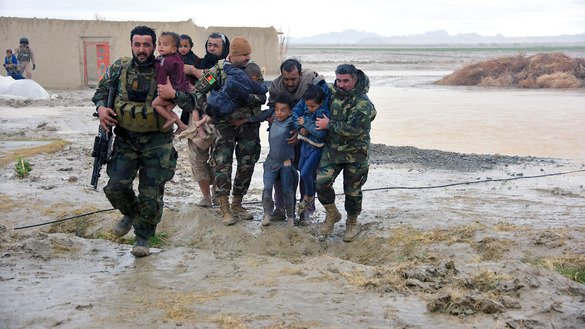 Afghan security forces carry children from their flooded homes in Arghandab District, Kandahar Province, March 2. [Javed Tanveer/AFP]