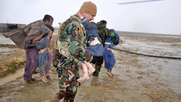 Afghan Air Force personnel carry children after flooding hit their homes in Arghandab District, Kandahar Province, March 2. [205th Atal Corps of the Afghan National Army/Facebook]