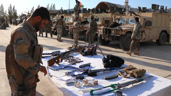 Afghan border forces March 13 in Herat Province display Taliban weapons that they seized during a retaliatory attack on militants in the province. [Omar]