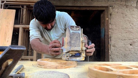 Mohammad Rahim, 29, makes candy trays at his shop in Narang District on March 13. [Khalid Zerai]
