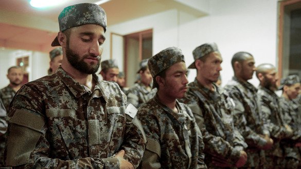 Afghan soldiers perform evening prayer in a mosque on the compound of the 207th Zafar Corps in Herat Province May 13. [Omar]