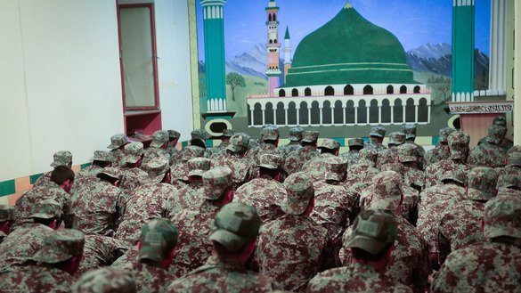 Afghan soldiers perform evening prayer in a mosque on the compound of the 207th Zafar Corps in Herat Province on May 13. [Omar]