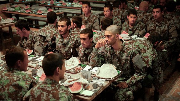 Afghan soldiers wait to break their fast right before Iftar at the compound of the 207th Zafar Corps in Herat Province on May 13. [Omar]