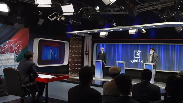 Presidential candidates Abdullah Abdullah (L) and Gulbuddin Hekmatyar take part in a presidential debate at TOLOnews TV station in Kabul September 25. Incumbent President Ashraf Ghani opted not to participate. [WAKIL KOHSAR/AFP]