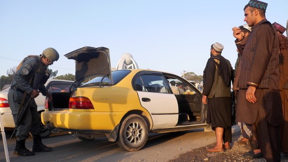 A police officer searches a taxi in Herat city September 24. [Omar]