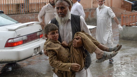 A volunteer carries an injured youth to hospital, following a bomb blast in Haska Mina District, Nangarhar Province, October 18. [Noorullah Shirzada/AFP]
