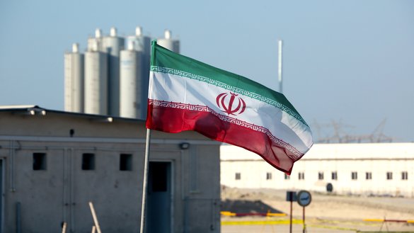 In this photograph taken last November 10, an Iranian flag flutters over the nuclear power plant in Bushehr. [ATTA KENARE/AFP]