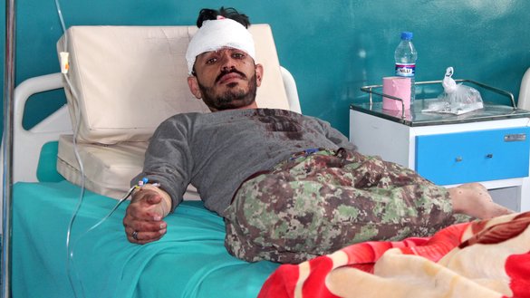 A wounded Afghan National Army (ANA) soldier rests inside a hospital after a Taliban attack on an Afghan National Army base in Gardez, Paktia Province, on May 14. [STR/AFP]