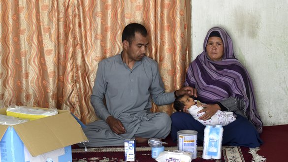 Hasan Ali, 32, his wife, Zia Gul, 28, and their newborn daughter Roya, are shown at home on the outskirts of Kabul May 22 after they received relief aid from a charity. They survived a terrorist attack on a maternity ward in Kabul May 12, when gunmen posing as members of the security forces rampaged through the facility run by Doctors Without Borders (MSF). The massacre shocked a country long accustomed to brutality after decades of war. [Wakil Kohsar/AFP]