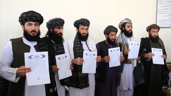 Former Taliban fighters released from Kandahar prison on June 2 hold commitment letters in which they promise not to return to the battlefield. [Raziq Kandahari] 