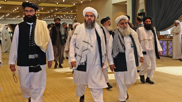 Taliban delegates attend the signing of a US-Taliban agreement in Doha, Qatar, February 29. [Karim Kaafar/AFP]