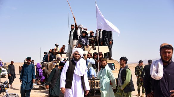 In this photo taken on June 17, 2018, Taliban militants and residents stand on an armoured Humvee vehicle of the Afghan National Army (ANA) as they celebrate ceasefire on the third day of Eid in Maiwand District, Kandahar Province. [JAVED TANVEER / AFP]