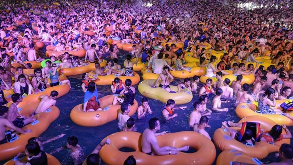 Pool-goers August 15 watch a performance as they cool off in Wuhan, China. [STR/AFP]