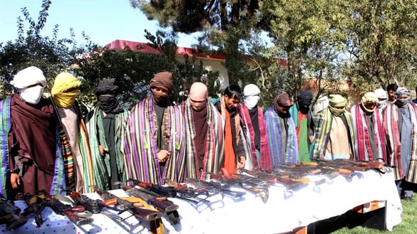 A group of 20 Taliban militants surrender their weapons as they renounce violence October 13 in Qala-e-Naw, Badghis Province. [Mirwais]