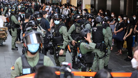 Police officers prepare to search civilians inside a cordon area during a celebration of China's National Day in Hong Kong on October 1. [May JAMES / AFP]