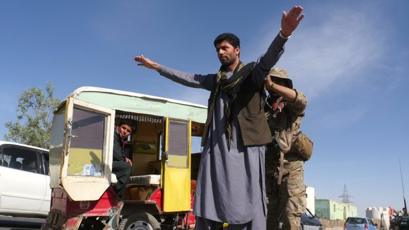 An Afghan police officer searches a traveller at a checkpoint in Guzara district, Herat province, April 23. [Omar/Salaam Times]