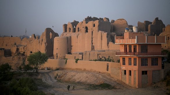 Men walk along a pathway near an old palace at Qala-e-Kohna, a historic site in Lashkargah, the capital of Helmand province, on March 27. [Wakil Kohsar/AFP]