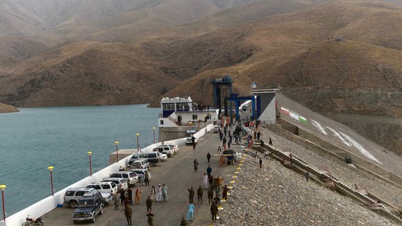In this photograph taken June 2, 2016, Afghan National Army soldiers and labourers walk over Salma dam east of Herat city. [Aref Karimi/AFP]