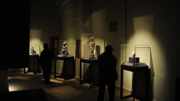 Afghan visitors look at displays of Afghan heritage at the Kabul Museum in Kabul on October 13, 2012. [Jawad Jalali/AFP]