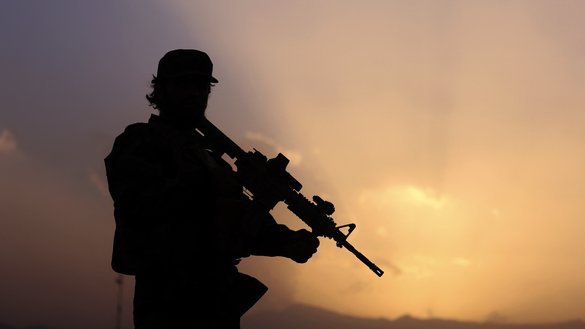 A Taliban fighter stands guard as the sun sets in Kabul September 12. [Karim Sahib/AFP]