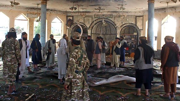 Taliban fighters investigate inside a Shia mosque after a suicide bomb attack in Kunduz on October 8. [AFP]