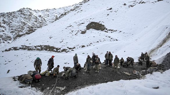 People search for emeralds near the mining area on a mountain in the Mikeni Valley in Panjshir province on January 12. [Mohd Rasfan/AFP]