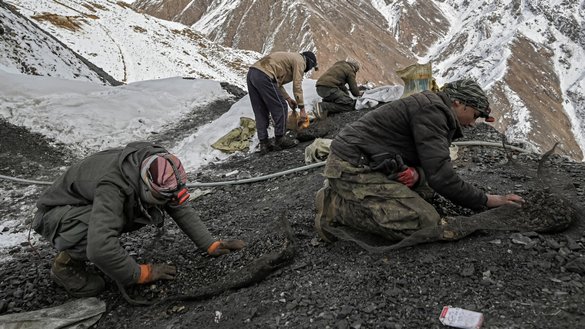 Workers search for emeralds on a mountain near the mining area in the Mikeni Valley on January 12. [Mohd Rasfan/AFP]